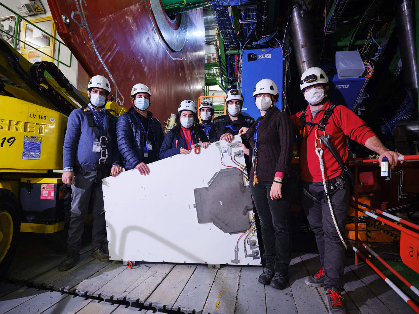 Caption: RPC team showing a demonstrator chamber before installation.  Credits: Traczyk, Piotr 